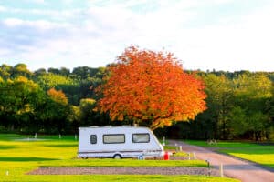 Caravan trailer in autumn holiday park